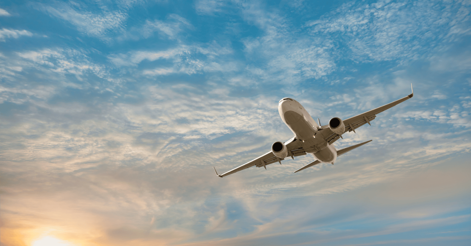 Airfreight Airplane flying over sea with sunset