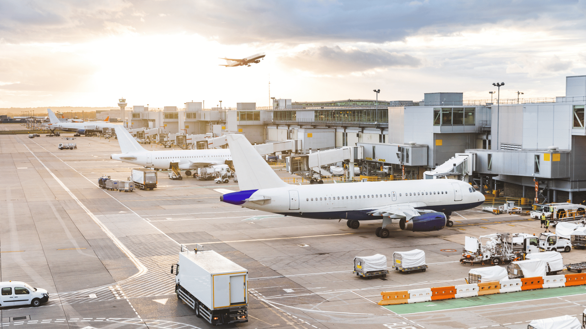 Busy airport view with airplanes and service vehicles