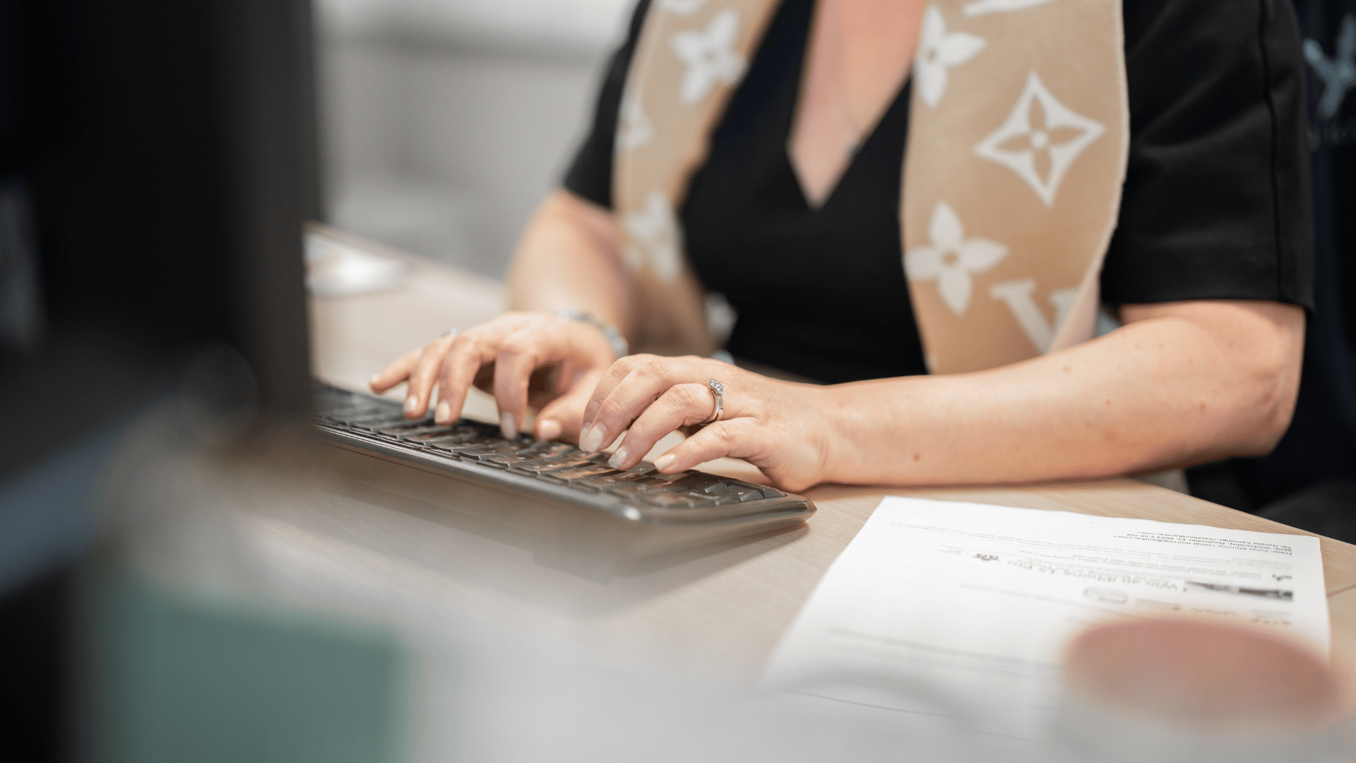 Jenkar staff member typing on computer