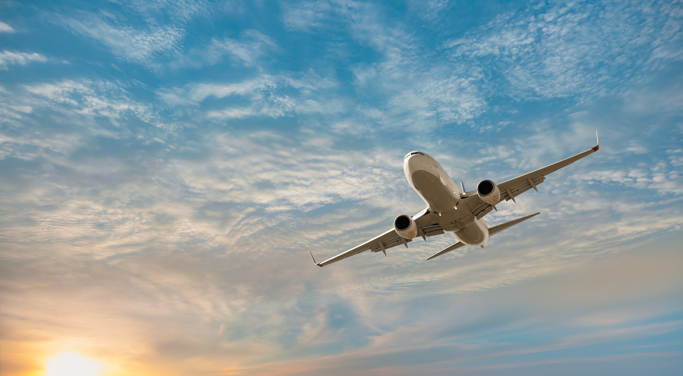 Airfreight Airplane flying over sea with sunset