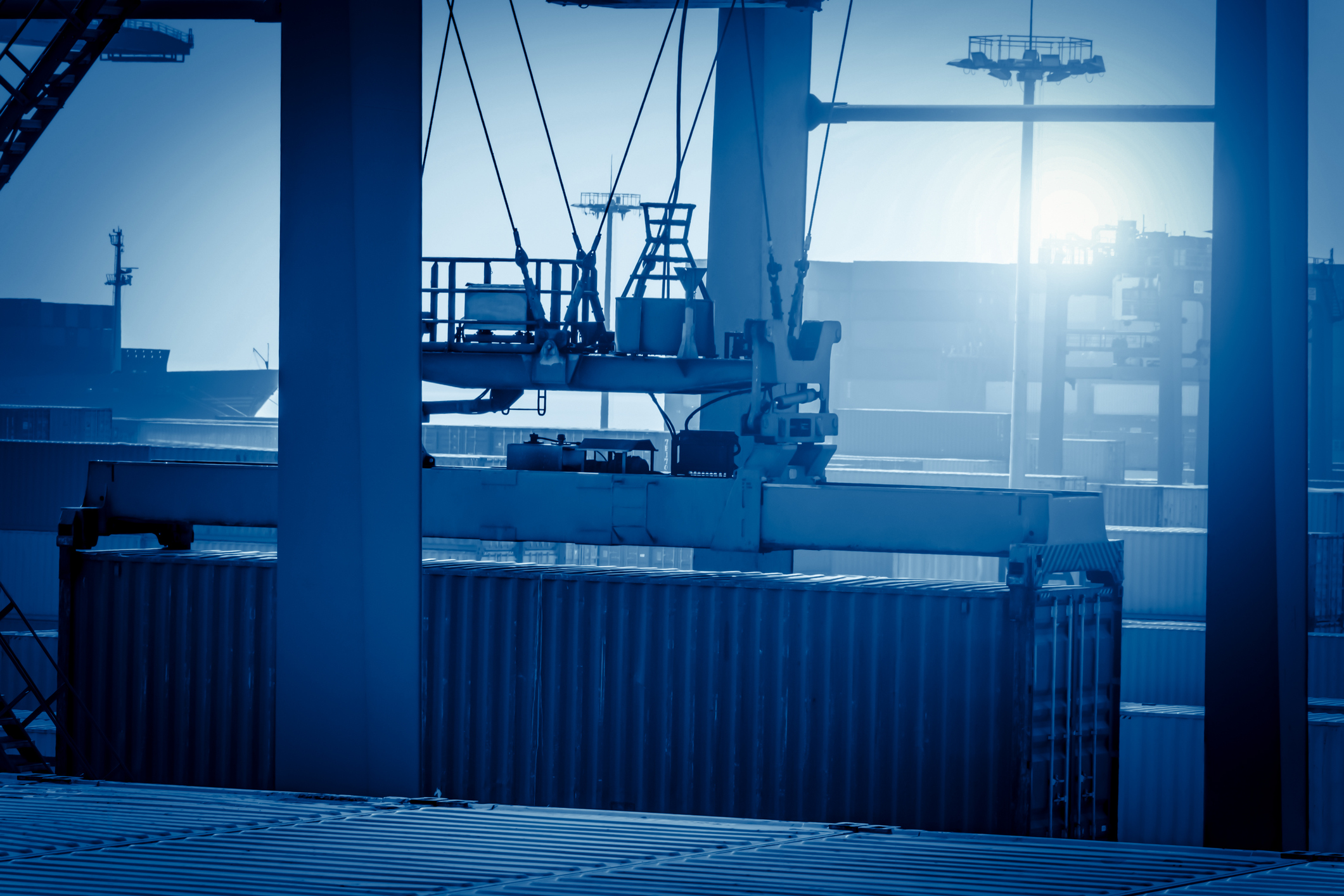 cargo container being moved in shipping yard