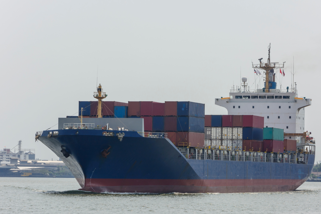 Ship loaded with containers travelling through sea