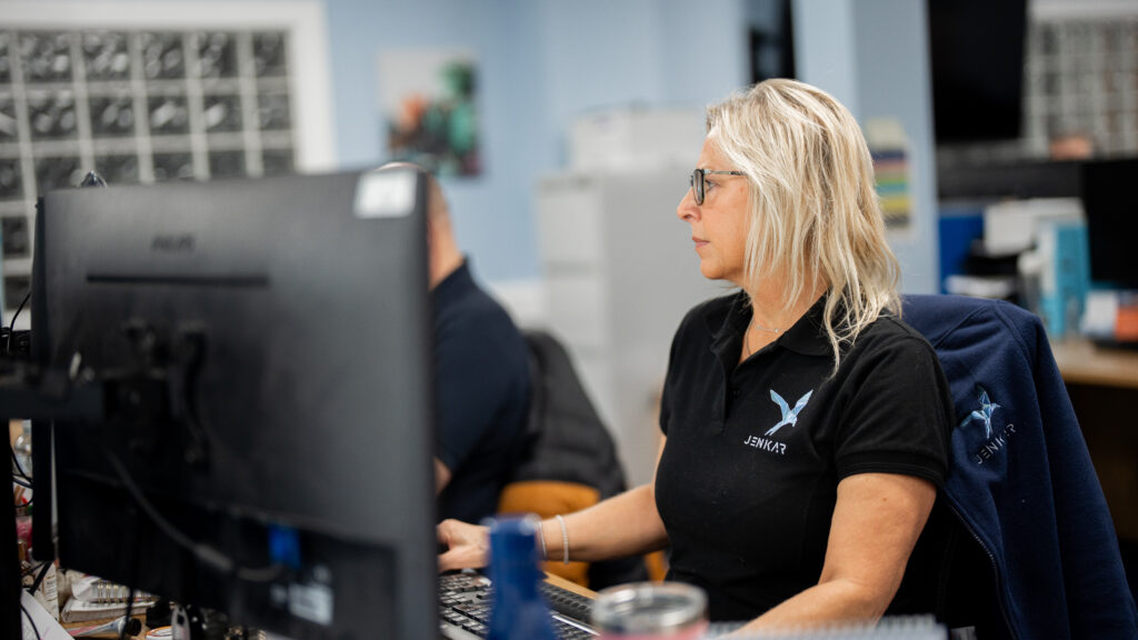 Jenkar employee working on computer