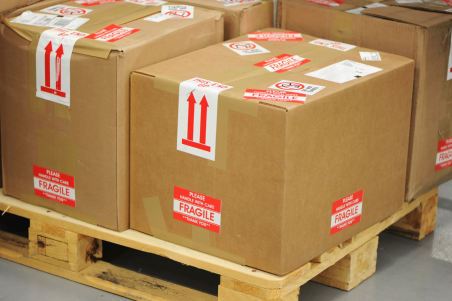 Boxes containing fragile products being stacked on a pallet