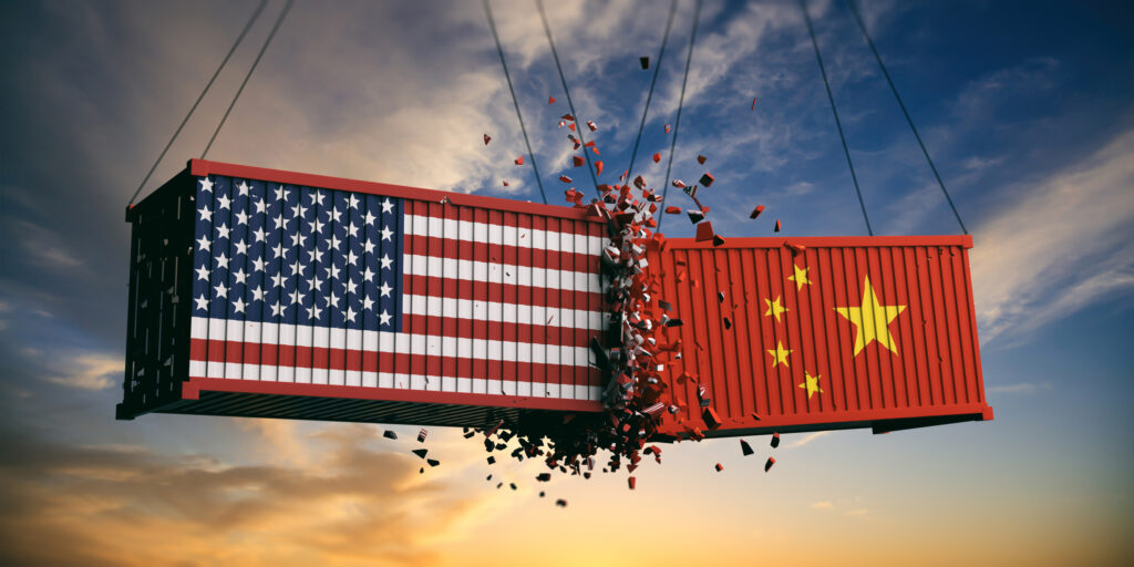 USA and China trade war. US of America and chinese flags crashed containers on sky at sunset background