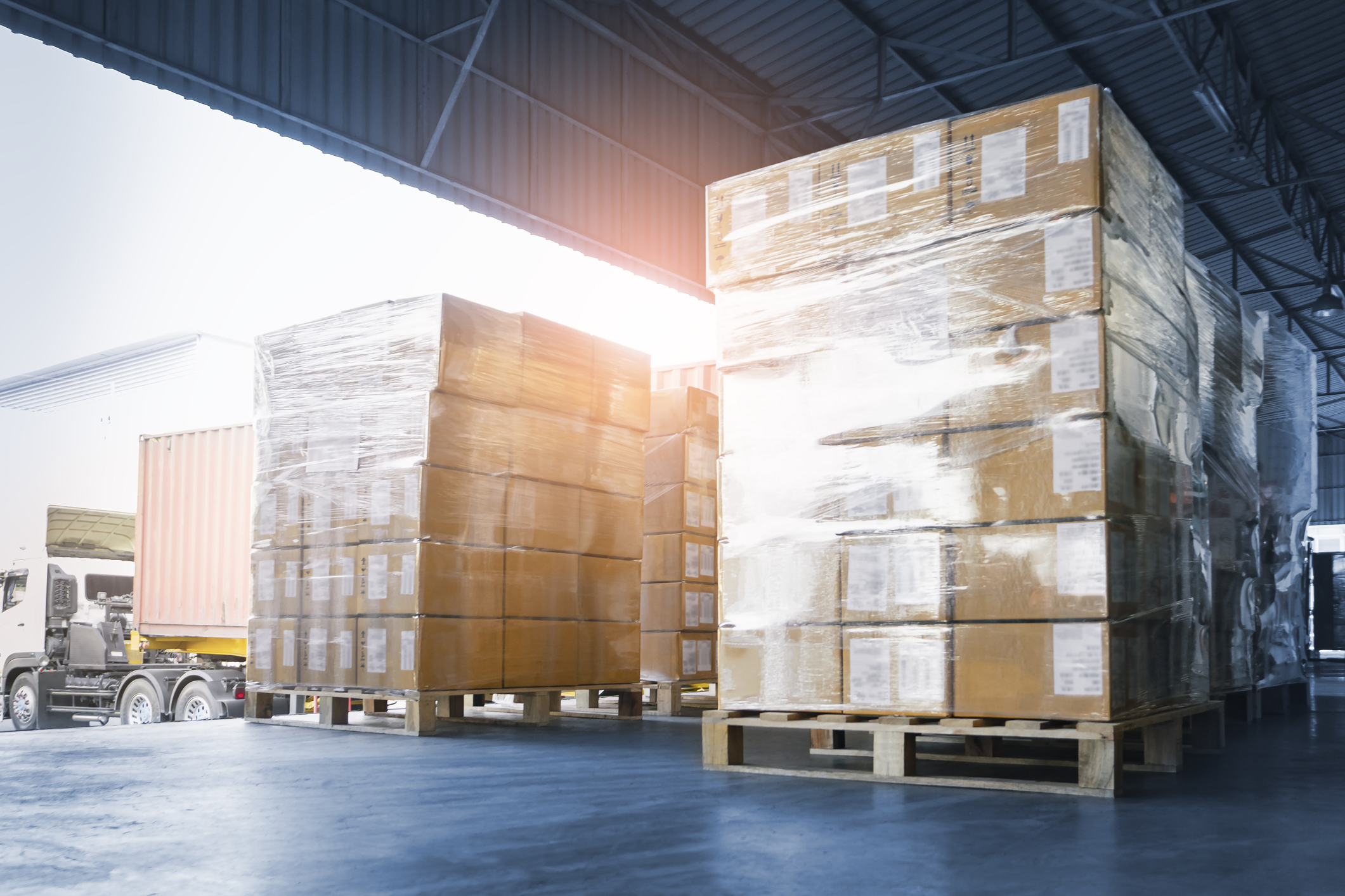 Stacked of Package Boxes Loading into Container Truck. Truck Parked Loading at Dock Warehouse. Delivery Service. Shipping Warehouse Logistics. Shipment Freight Truck Transportation. stock photo