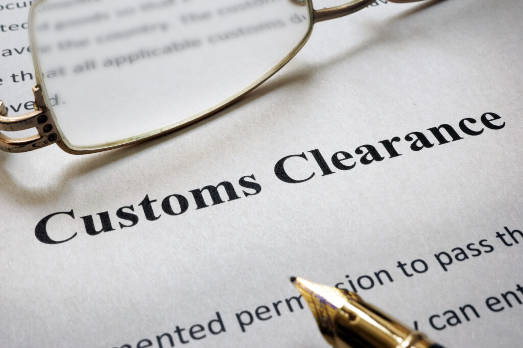 customs clearance document with pen and glasses on paper