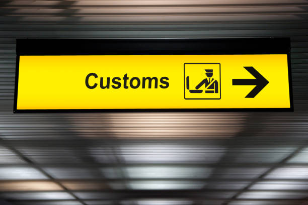 airport customs declare sign with icon and arrow hanging from airport ceiling at international terminal. customs declare for import and export concept airport customs declare sign with icon and arrow hanging from airport ceiling at international terminal. customs declare for import and export concept customsairport stock pictures, royalty-free photos & images