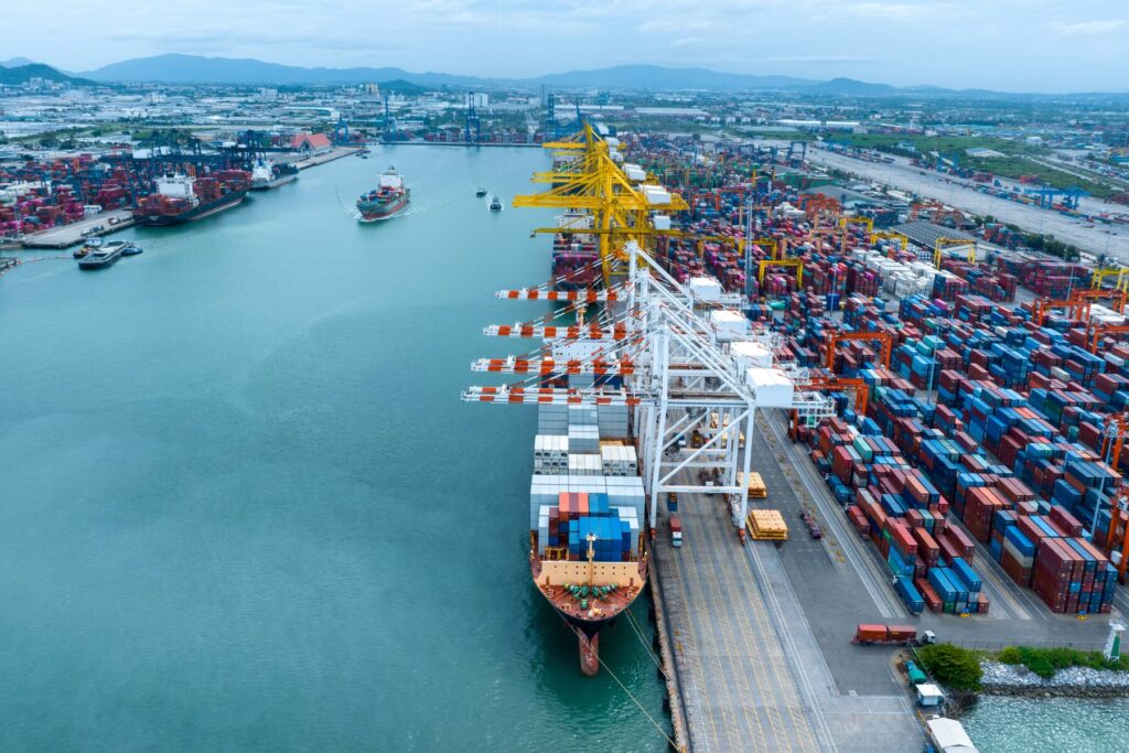 shipping port with containers being loaded onto ships.