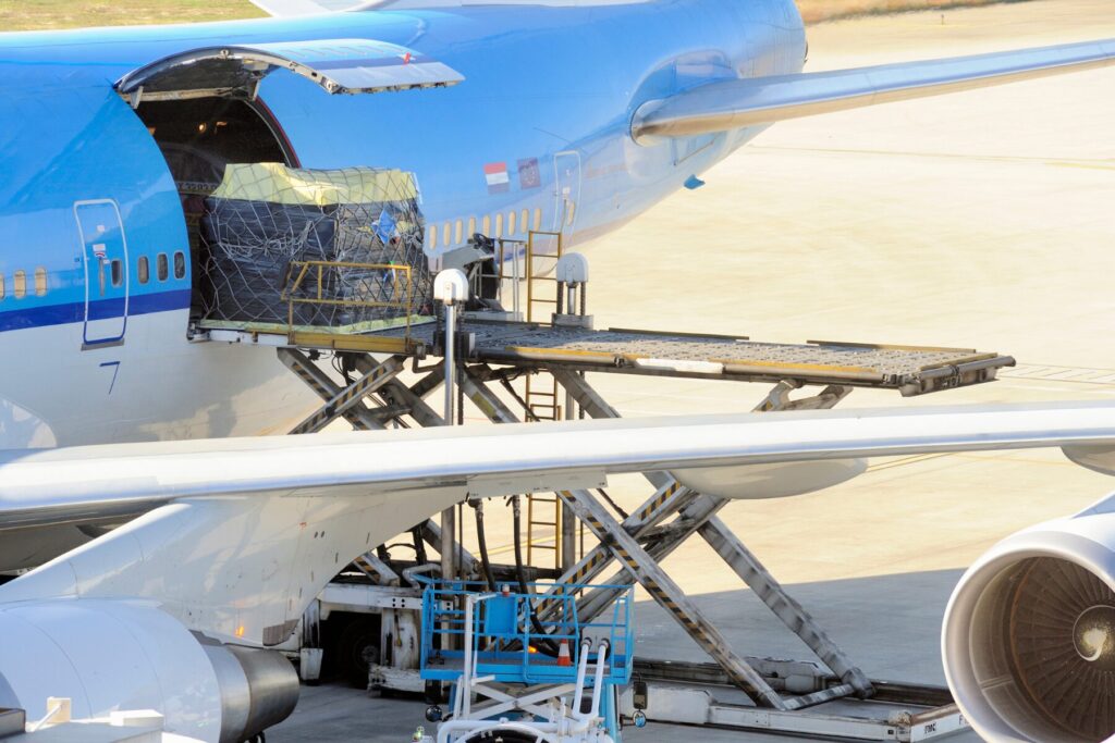 Cargo being loaded into the cargo hold of an airplane before it is due to take off