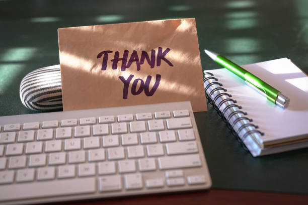 Thank you card Thank you card inside a brown envelope left on an office table thank you envelope stock pictures, royalty-free photos & images