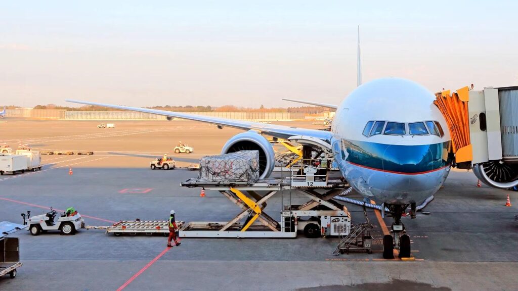 This image is showing cargo being loaded onto an airplane before it is due to take off.